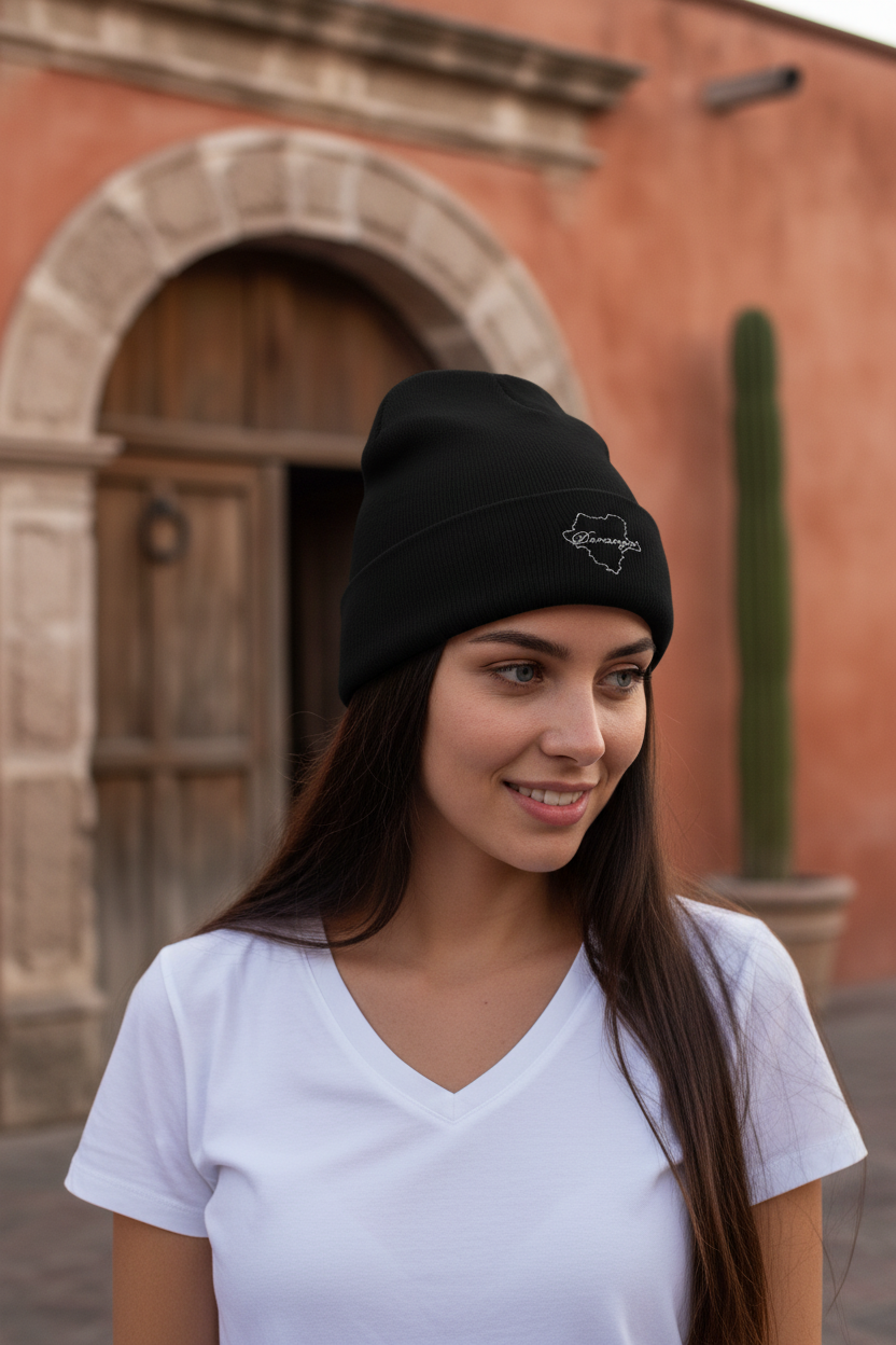 A person wearing a black Durango embroidered beanie hat with a logo on the front.