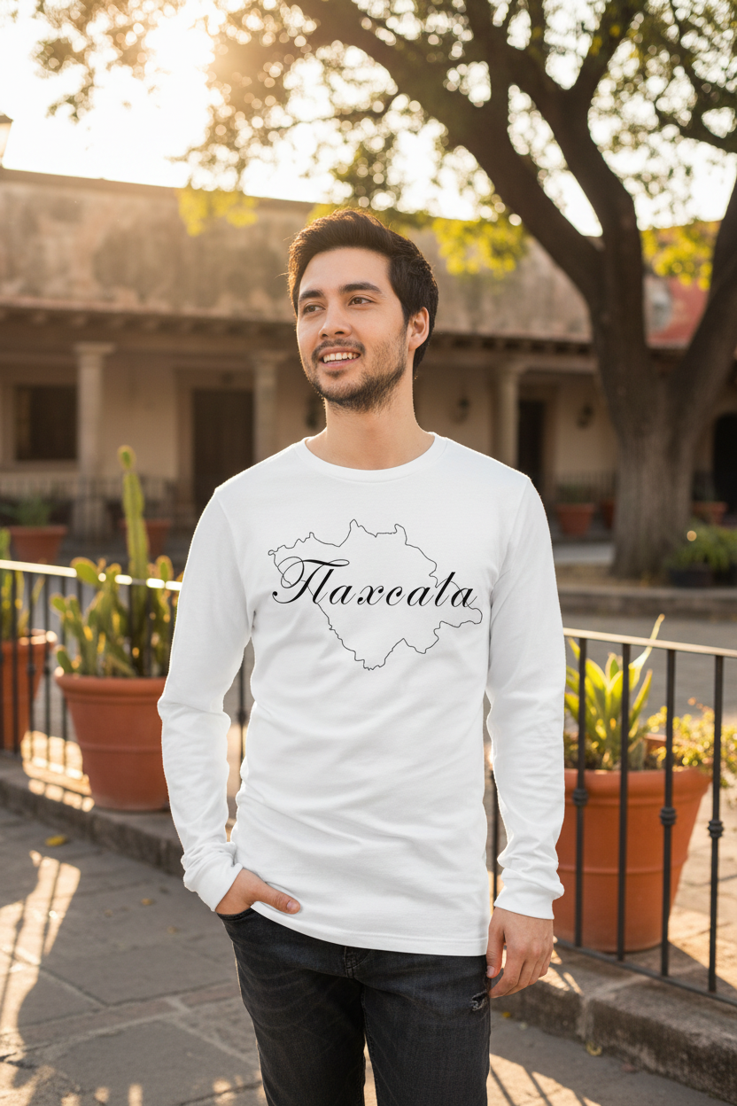 A person wearing a white long sleeve T-shirt with the text 'Tlaxcala' on it, standing against an athletic heather background.
