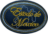 An oval embroidered patch featuring the text 'Estado de México' in gold cursive lettering over a white map outline, all on a whitebackground with a white and gold stitched border.