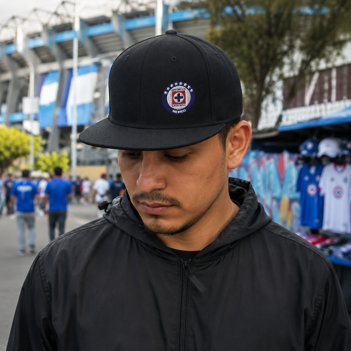 A Mexican model wearing the Cruz Azul snapback hat in a realistic outdoor lifestyle setting, with the front design clearly visible. The Cruz Azul snapback hat design, shape, and colors are shown clearly in a natural casual scene.