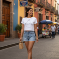 A woman wearing a white crop t-shirt with 'Mexico City' printed in black text on the front.