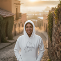 A white hoodie with the word 'México' printed in black lettering on the front, featuring a hood and a front pouch pocket.