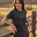 A woman wearing a black denim t-shirt with the text 'Michoacan' written on the front.