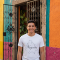 A person wearing a white short-sleeved T-shirt with the text 'Nayarit' printed in a stylized font.