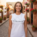 A person wearing a white sleeveless muscle shirt with the text 'Oaxaca' written across the front in black.