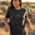A woman wearing a black denim t-shirt with the text 'Queretaro' written on the front.