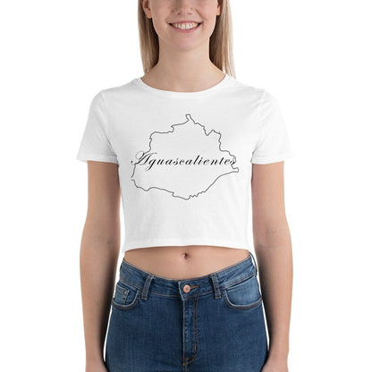 A woman wearing a white cropped T-shirt with 'Aguascalientes' text and a silhouette of a person, paired with blue jeans.