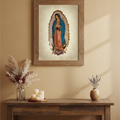 A framed religious print of Our Lady of Guadalupe hanging on a beige wall above a rustic wooden console table decorated with candles and dried flowers.