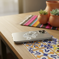 Silver smartphone placed on a wooden café table with a die-cut bubble-free sticker reading “Zacatecas” in cursive — surrounded by warm lighting, patterned tiles, and rustic décor, symbolizing Mexican regional pride and artisanal design.