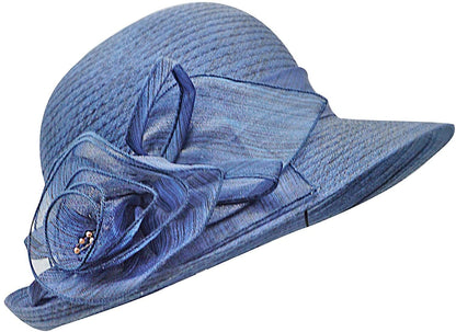 A blue organza fascinator hat with a bow detail and a translucent flower decoration on the side.