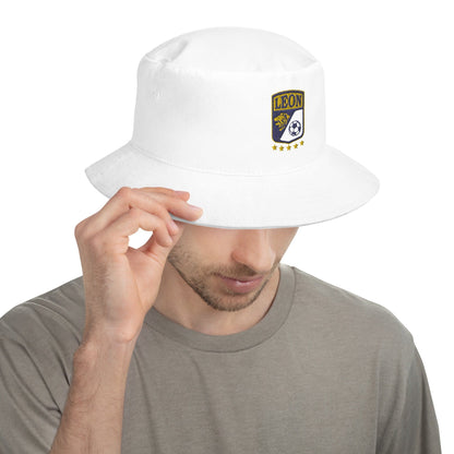 A person wearing a white Club Leon bucket hat with a logo on the front.