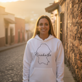 A woman wearing a white unisex hoodie with 'Coahuila' text on it.
