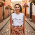 A woman wearing a white unisex muscle shirt with the text 'Colima' printed on the front.