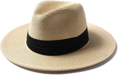 A beige wide brim Panama sun hat with a black band and a slight fedora shape.