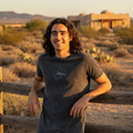 A person wearing a black denim t-shirt with the text 'MEXICO' printed on the front.
