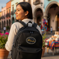 An oval-shaped black PU leather patch with 'Michoacán' embroidered in gold along with a snake skin design detail, attached with a velcro backing.