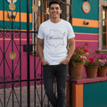 A person wearing a white, short-sleeved crew neck t-shirt with the text 'Morelos' printed in a stylized font.