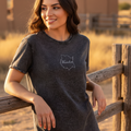 A woman wearing a black denim t-shirt with the text 'Morelos' on the front.