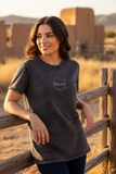 A woman wearing a black denim t-shirt with the text 'Morelos' on the front.