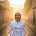 A woman wearing a white hoodie with the text 'Morelos' printed on the front.
