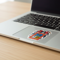 A sticker with the coat of arms of Aguascalientes, featuring a red shield with a blue sky and a white angel, on a laptop.