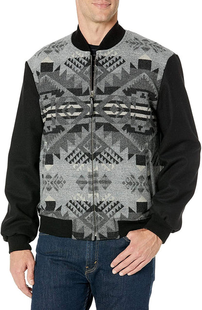 A man wearing a Pendleton men's zip jacket with geometric patterns on the front, primarily in black color, along with jeans.