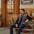 A man wearing a Pendleton men's zip jacket with geometric patterns on the front, primarily in black color, along with jeans.