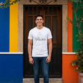 A person wearing a white short-sleeved T-shirt with the word 'Puebla' printed in black text.