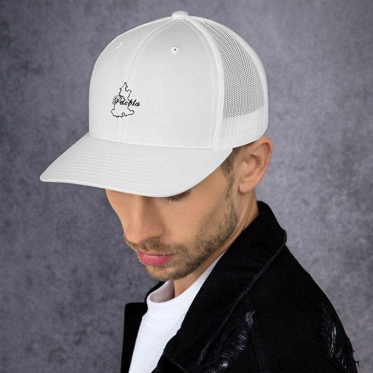 A person wearing a white trucker cap with a Puebla logo at the front.