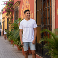A person wearing a white, short-sleeved unisex T-shirt with 'Quintana Roo' text and a map outline in black.