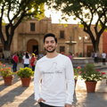 A person wearing a long sleeve white t-shirt with 'Quintana Roo' text and a graphic on the front.