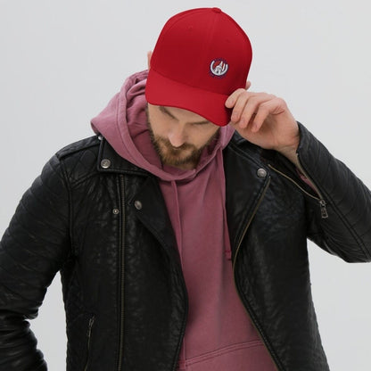 A person wearing a red baseball cap with a Atletico San Luis logo, red hoodie, and black leather jacket.