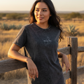 A woman wearing a black denim t-shirt with the text 'quintana roo' on the front.