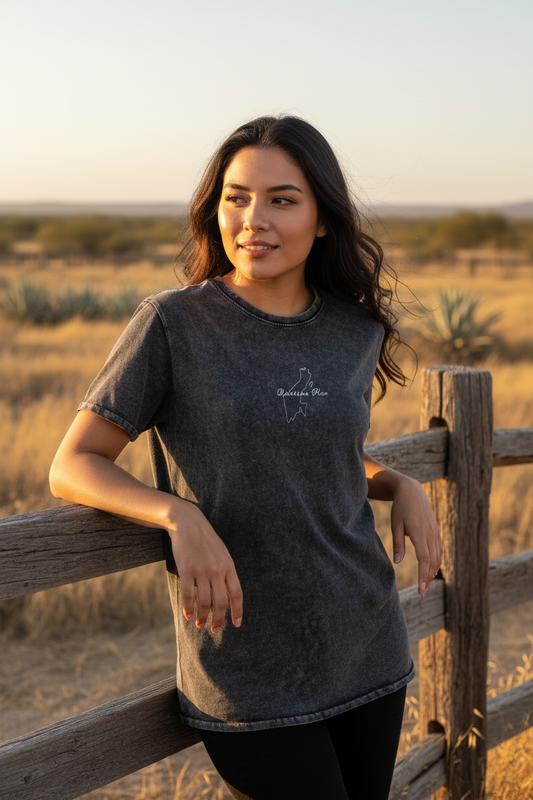 A woman wearing a black denim t-shirt with the text 'quintana roo' on the front.