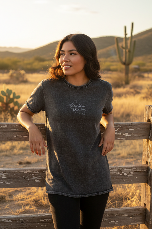 A woman wearing a black short-sleeved denim t-shirt with text on the front.