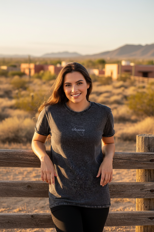 A woman wearing a black short-sleeved t-shirt with the brand name 'Sonora' written on the front.