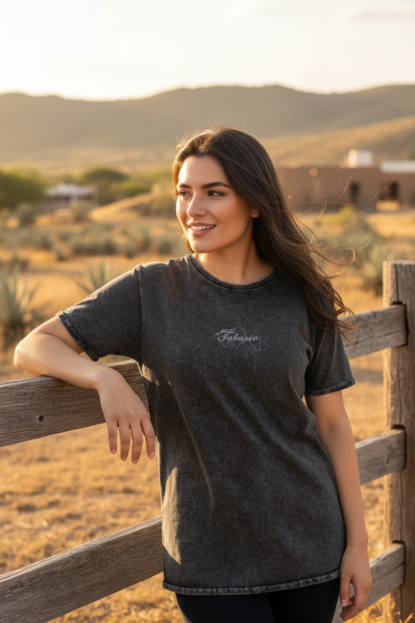 A woman wearing a black denim t-shirt with the Tabasco logo on the chest.