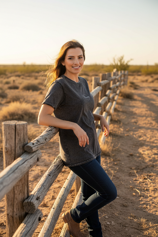 A woman wearing a black denim T-shirt with the text 'tlaxcala' on the front.