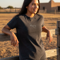 A woman wearing a short-sleeved black denim t-shirt with the text 'Veracruz' on the front.