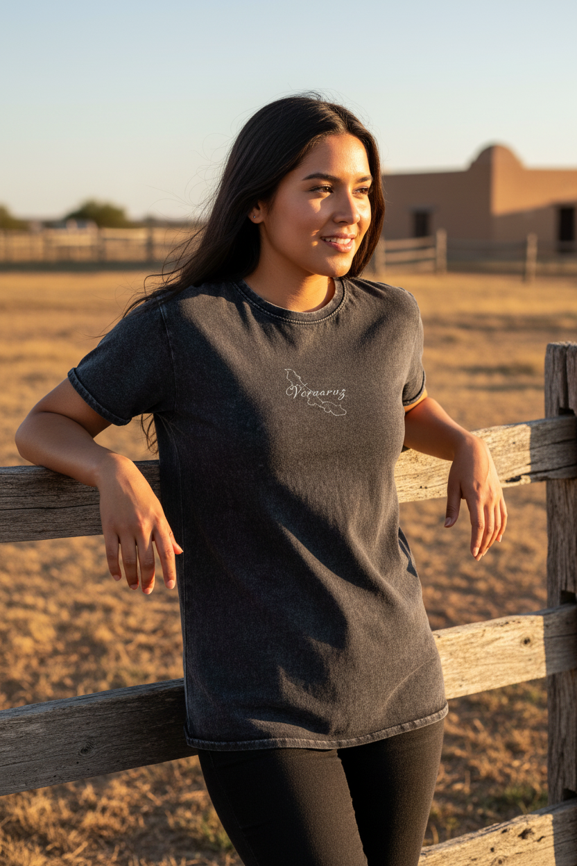 A woman wearing a short-sleeved black denim t-shirt with the text 'Veracruz' on the front.