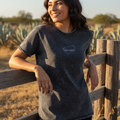 A woman wearing a black Yucatan denim t-shirt with the brand name visible on the chest area.