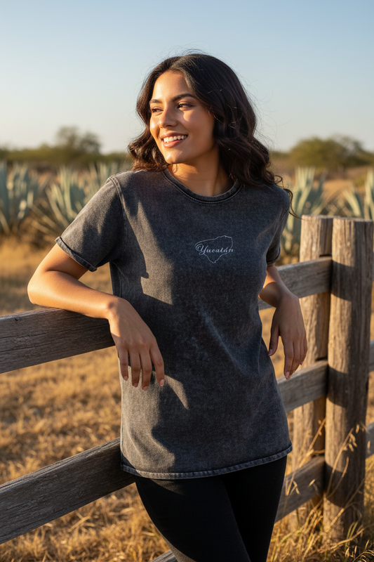 A woman wearing a black Yucatan denim t-shirt with the brand name visible on the chest area.