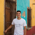 A person wearing a white short-sleeved T-shirt with 'San Luis Potosi' text printed on the front.