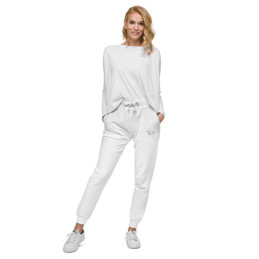 A female model wearing a white t-shirt and gray sweatpants with a drawstring, standing against a white background.