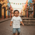 A young child wearing a white knitted t-shirt with the text 'San Luis Potosi' printed on it.