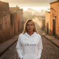 A woman wearing a white hoodie with the text 'Sonora' printed on the front.