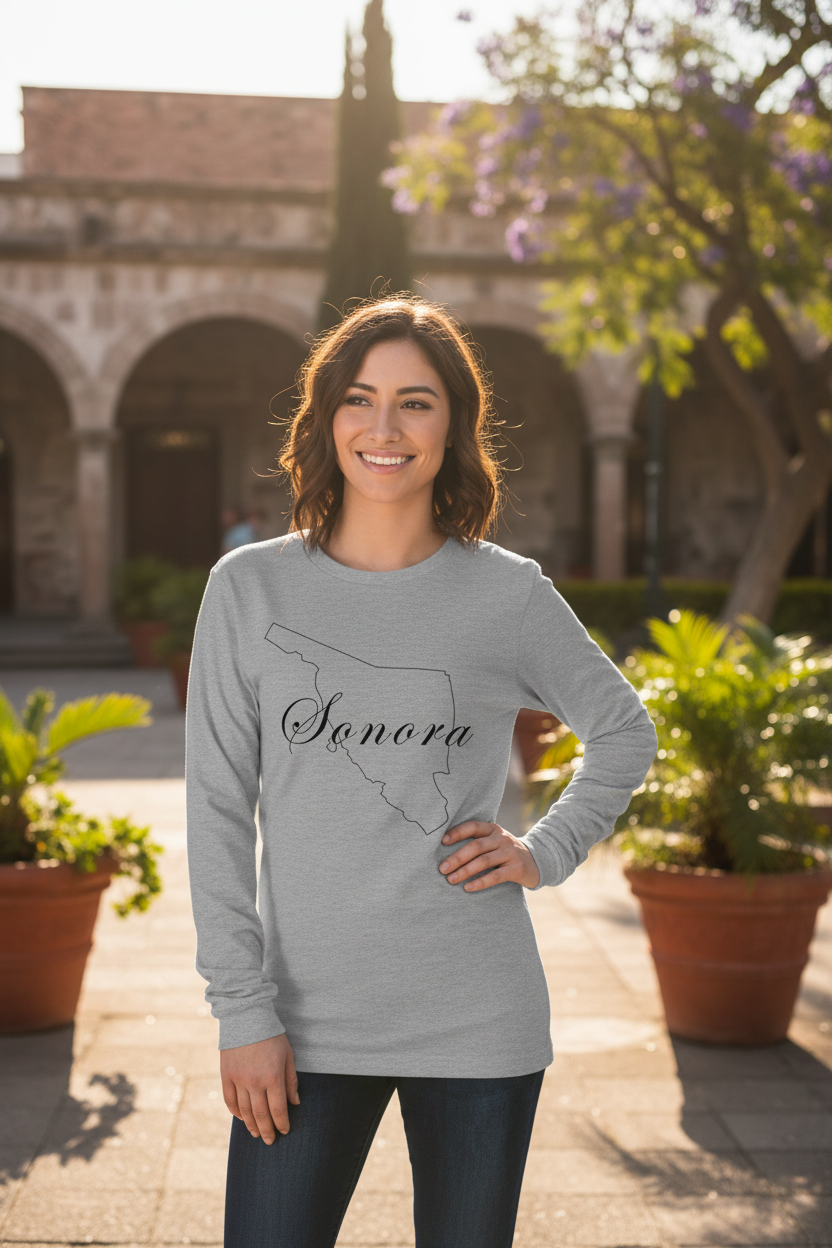 A woman wearing a gray long sleeve t-shirt with the text 'Sonora' on it.