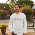 A person wearing a white long sleeve T-shirt with 'Tabasco' text on the front.