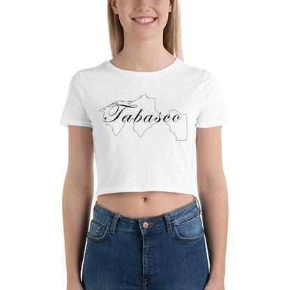 A woman wearing a white short-sleeved crop t-shirt with the text 'Tabasco' printed on the front, paired with blue jeans.