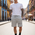 A person wearing gray fleece shorts with an elastic waistband and drawstring, featuring pockets and branded with the 'Tlaxcala' logo.